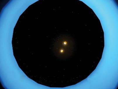 As seen from above, the two stars are in the center of a large disk of sand-sized grains.