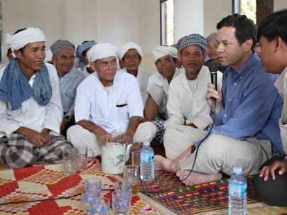 Adjunct Professor of the Humanities in the Program in Writing Alan Lightman sits in the mosque built by his and his wife's Harpswell Foundation with villagers, Muslim Chams (of the San Cham sect).