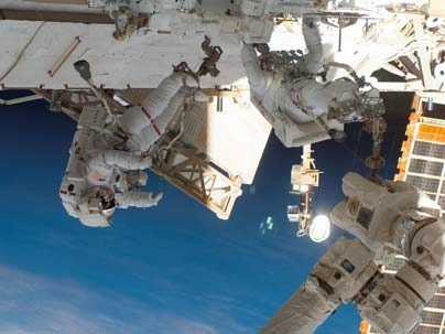 Endeavour astronauts Mike Foreman (left) and Rick Linnehan assemble the two-armed robotics system called a Special Purpose Dextrous Manipulator.