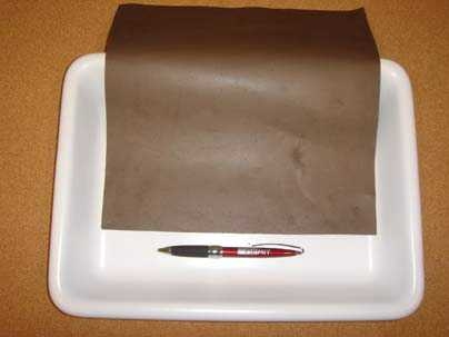 A swatch of MIT's new oil-absorbing nanowire mesh next to a pen for scale.