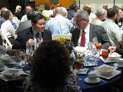 New members, Dick K.P. Yue and Michael G. Imbeault, share MIT memories at the QCC Induction luncheon.
