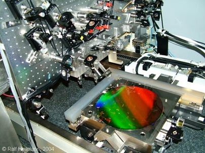Gratings used to manipulate X-rays for future space telescopes and other applications, like tiny miniaturized venetian blinds, were created using this interference lithography patterning tool, called the nanoruler, developed at MIT's Space Nanotechnology Laboratory. The colorful, diffracting wafer at center has a diameter of 12 inches.