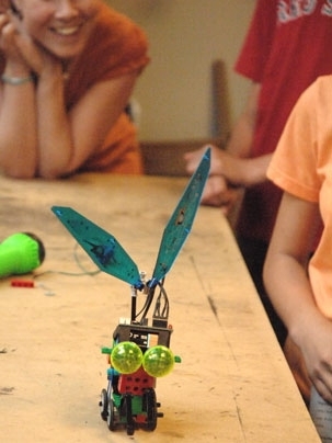 An "insect robot" built by a team from the O'Maley Middle School in Gloucester, MA trundles down a table at the Edgerton Center at MIT.