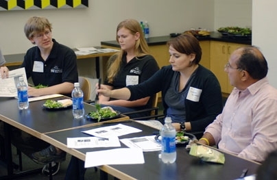 Ray Magliozzi, right, of NPR's 'Car Talk,' listens to MIT students and staff on Sept. 19. Magliozzi and his brother, Tom, who are alumni of MIT, toured the campus to see up-and-coming energy technologies being developed at the school. From left are sophomores Mike Roberts and Rachel Roberts of the MIT Solar Electric Vehicle Team, and MIT staff member Brenda Richard.