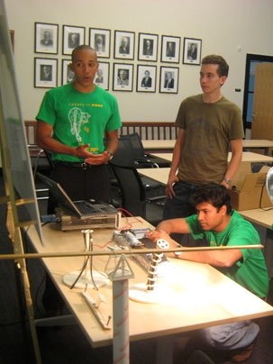 Team Heliotrope demonstrates its sun-tracking technology that won first prize in an MIT competition aimed at developing innovative energy technologies. At left is team member George Whitfield, a graduate student in materials science. His teammate and fellow grad student Vyom Sharma is at right. The third member, Forrest Liau, is not shown. <a onclick="MM_openBrWindow('madmec-4-enlarged.html','','w...