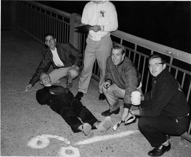 Alumnus Oliver Smoot "62 is used to measure the Massachusetts Avenue bridge in 1958.