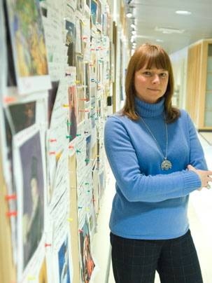 Elizabeth Kubicki, an assistant in the Microsystems Technology Laboratories, stands outside the art contest board near Professor Walter Lewin's office.