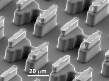 These cups on a microchip trap cells so they can be paired up and fused together.