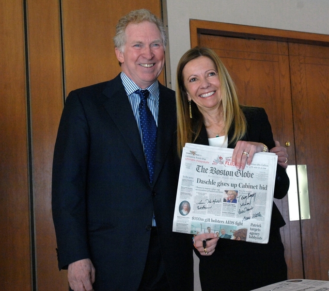 Phillip (Terry) and Susan Ragon hold a copy of The Boston Globe issue that announced the creation of the Phillip T. and Susan M. Ragon Institute. All the principals -- the Ragons as well as the leaders of MGH, MIT and Harvard -- signed the newspaper.