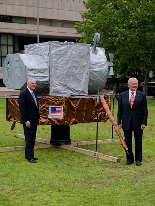 Neil Armstrong (left) and Buzz Aldrin ScD '63 stand beside a replica of their lunar landing module that was recently built by MIT students as a "hack" that appeared on top of the great dome.
