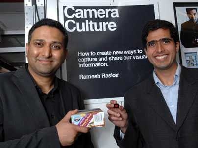Ramesh Raskar, left, holds box with conventional barcode,
while Ankit Mohan holds a prototype of new Bokode.