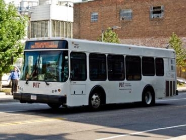 An MIT shuttle bus drives down Vassar Street.