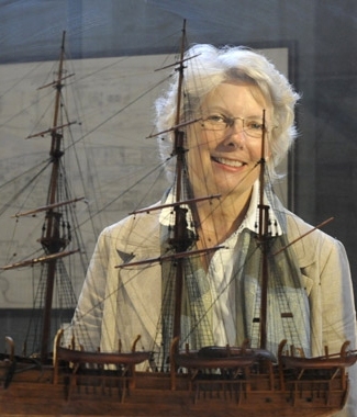 Melville scholar Wyn Kelley, with a model of the 19th century American whaleship, the Charles W. Morgan, one of 40 full-hull models in MIT’s Hart Nautical Gallery.