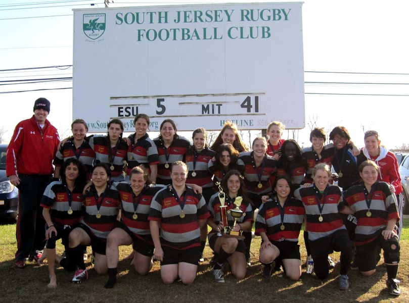 The MIT women's rugby club team poses with its hardware after winning the National Championship.