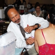 MIT Medical physician assistant George Taylor administers an H1N1 flu shot to a student at the Nov. 17 clinic at MacGregor House.