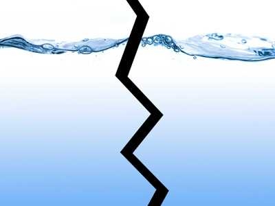 Bubbly wave of water with a jagged black line splitting the image in half