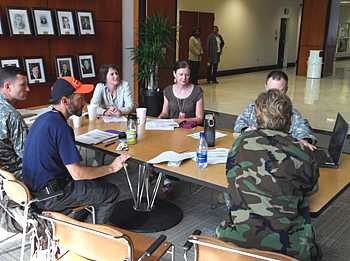 Marc Zissman (in orange and blue cap) attends a meeting at the U.S. embassy in Port-au-Prince to plan activities for assessment of the military's Haiti relief operation.