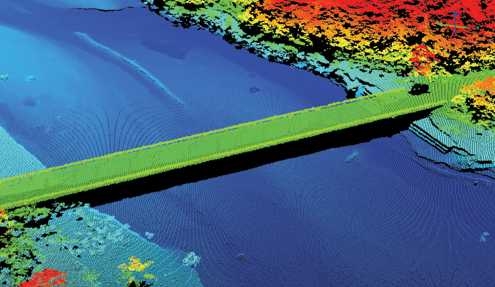 This 3-D image provided by the Lincoln Laboratory ALIRT system allows USSOUTHCOM to see the trafficability of the bridge. The colors indicate the relative heights of the terrain and structures being imaged; the spectrum shades from red at the highest height through orange, yellow, green, aqua, and finally blue at the low end. The black object is a vehicle that is crossing the unobstructed bridge.