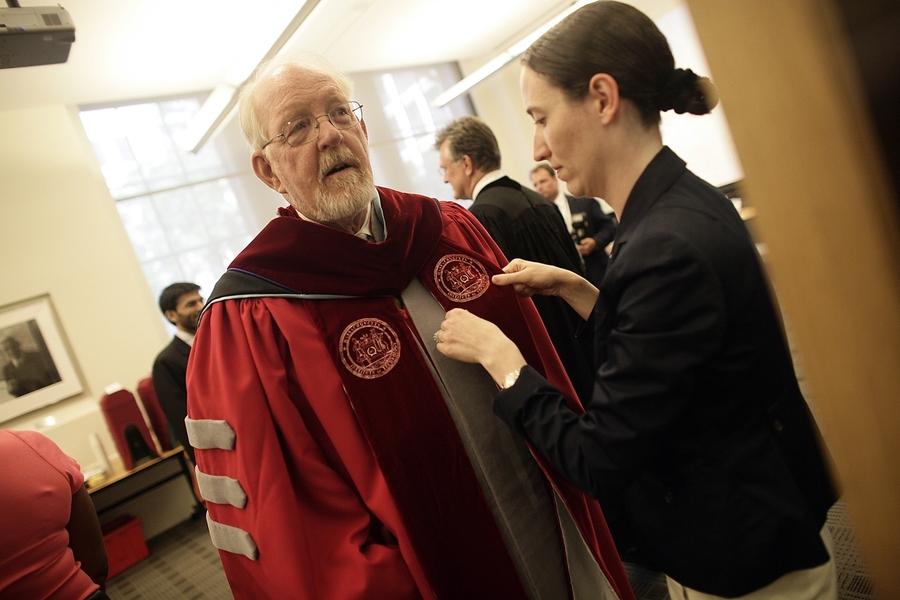 Institute chaplain Robert Randolph dons his regalia prior to the Commencement ceremonies.