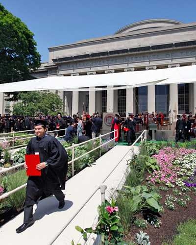 A graduate leaves the stage after receiving his diploma.