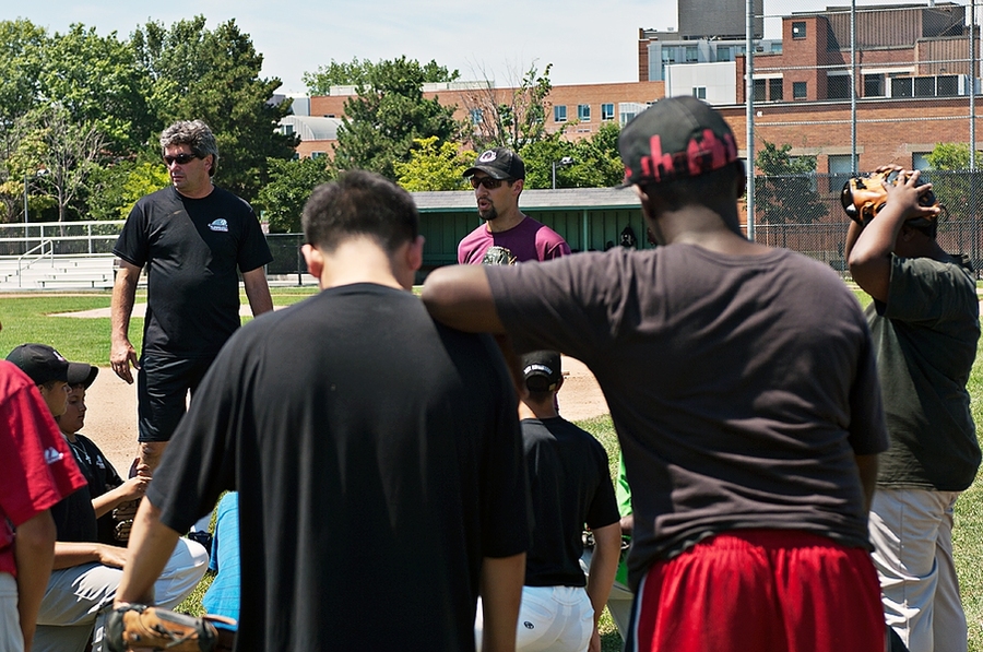 After warm ups, but before hitting the field, Andres talks to the players about showing respect for the team and the importance of staying positive during the game.