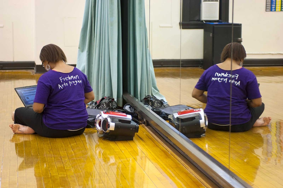 An instructor prepares music for dance practice as part of pre-Orientation’s Freshman Arts Program.