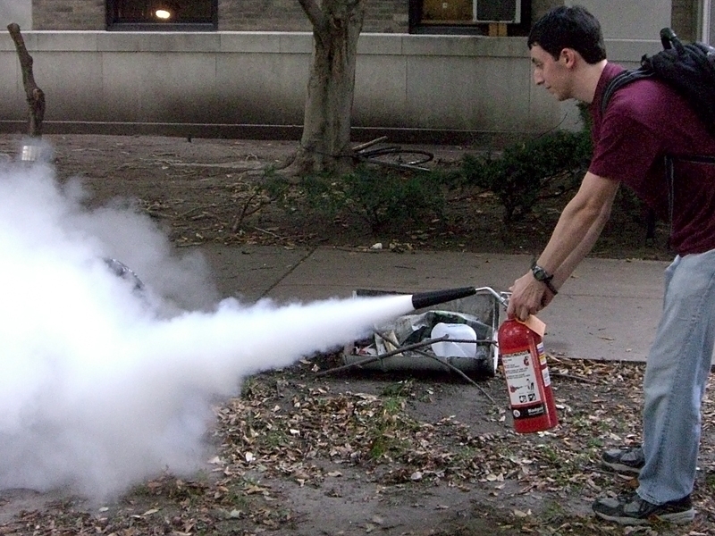 A student discharges a carbon-dioxide extinguisher. “Some students were surprised that even for a small fire, the extinguisher may not always put it out,” said Abigail Licnikas, Environmental Health and Safety Program Manager for DSL. “There is no guarantee that, even for a small fire, the extinguisher is going to put it out and keep it out.”