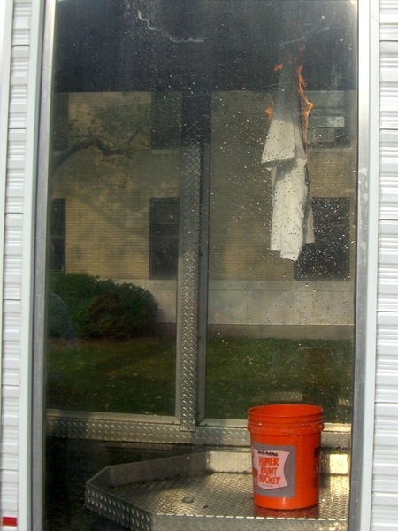 The Cambridge Fire Department demonstrated a controlled burn for students in the demonstration trailer owned by the Massachusetts Department of Fire Services. Firemen lit a T-shirt on fire to show students how quickly a fire can spread before the temperature is high enough to set off a sprinkler system –– between 150 to180 degrees.