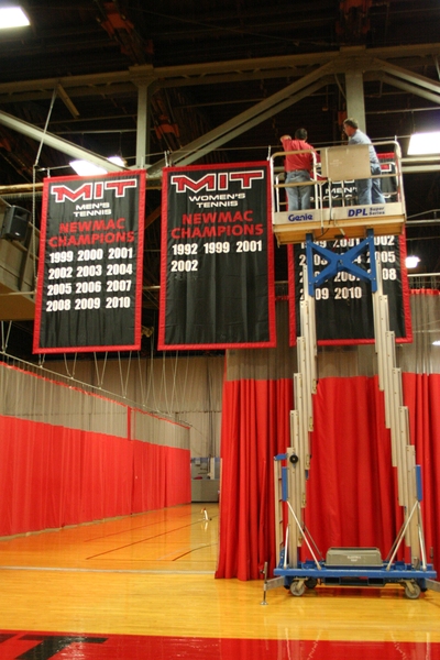 Workers installed the new banners in Rockwell Cage, which commemorate MIT’s conference championships.