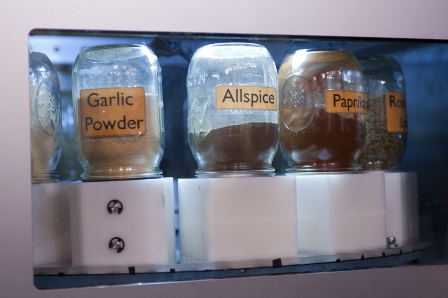 A close-up of the inside of the spice-dispensing machine.