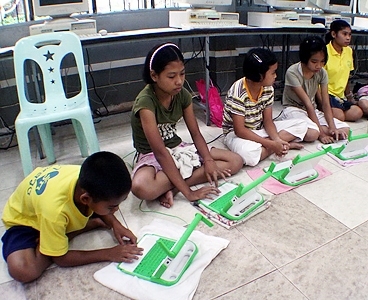 Children participate in a One Laptop Per Child pilot program in Thailand
