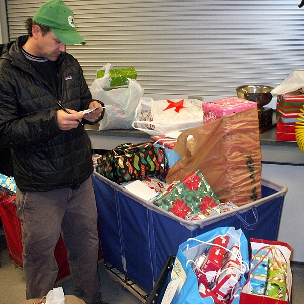 MIT sailing coach Matt Linblad, seen here making his list and checking it twice, organized the fourth-annual DAPER holiday toy drive.