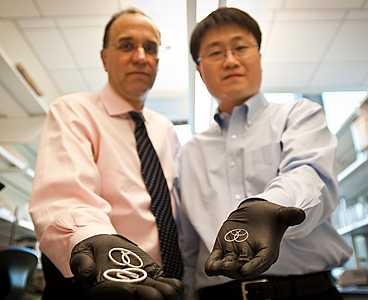 Michael Cima, left, and Heejin Lee SM ’04, PhD ’09 display the drug-delivery devices they developed to help treat interstitial cystitis. Cima holds the device built for humans; Lee's is sized for a rabbit.