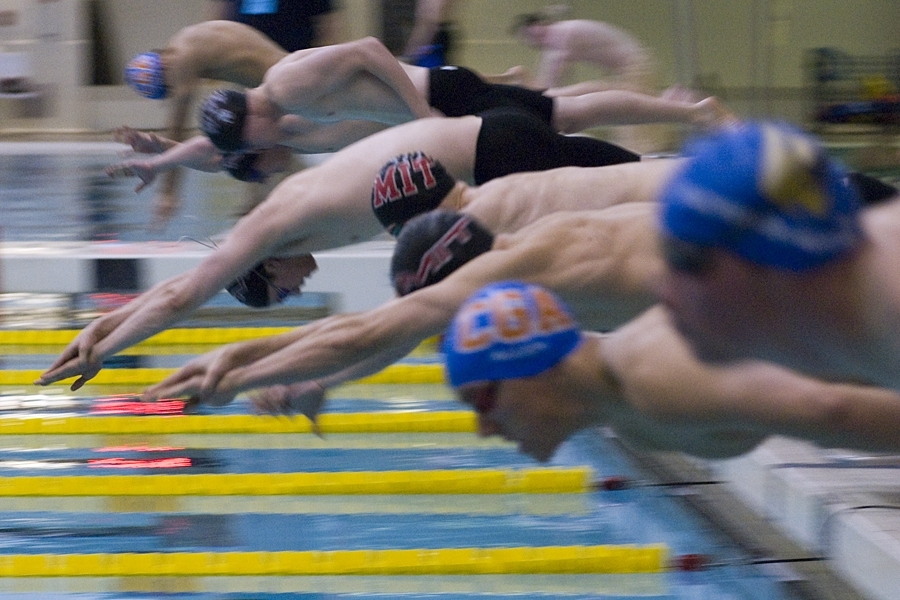 A heat with multiple MIT swimmers leaves the blocks on Saturday night. On Sunday, MIT swept the final six swimming events to capture its third consecutive conference crown.