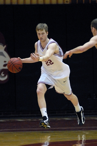 Junior guard Daniel McCue brings the ball upcourt against Springfield College in the first round.