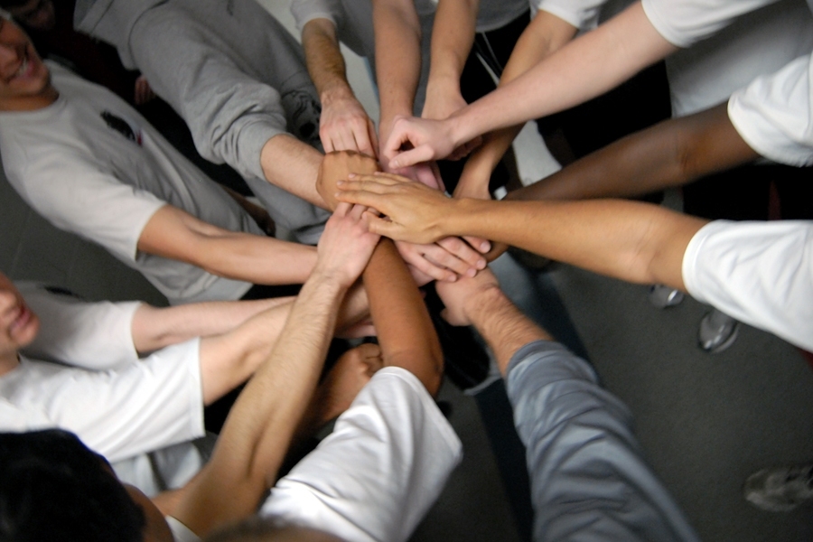 After a pre-game meeting — which included a discussion of how the rules would be adjusted for playing inside a hockey rink — the team huddled up before heading out to the field.