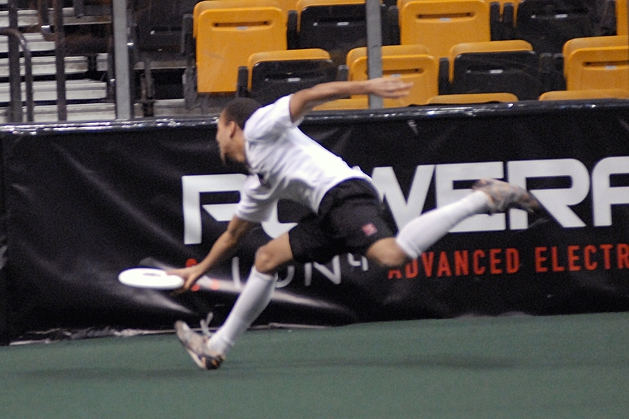 Malik Miller turns on the afterburners to make a full-speed, one-handed catch in the end zone for a score early in the game. Points are scored in ultimate Frisbee by catching the disk in an end zone, similar to football.