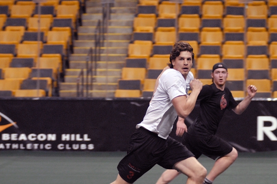 Alumnus Cody Rebholz (white shirt) covers a WPI receiver while on defense.