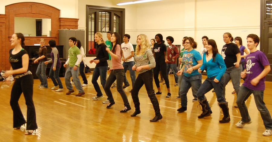 Instructor Jen Earls leads students through salsa basics as a warm-up.
