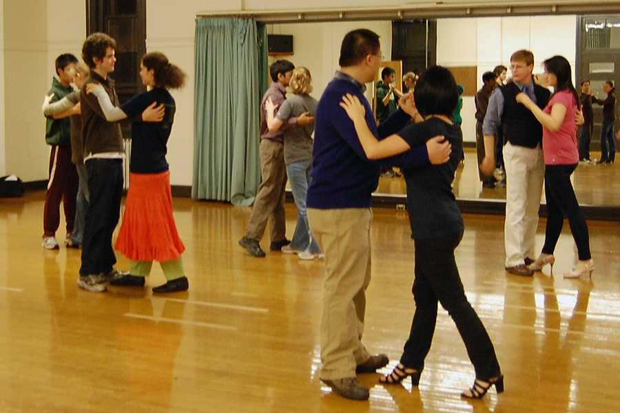 Instructor Tom Moore, back right, instructs students in ballroom dancing.
