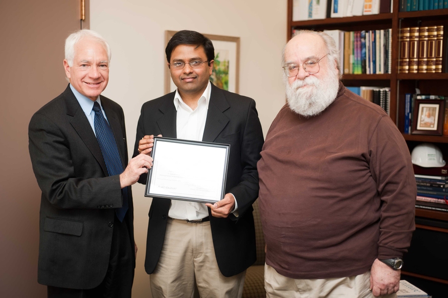 2011 Doherty Professorship in Ocean Utilization recipient Kripa Varanasi, center, with Vice President for Research and Associate Provost Claude Canizares, left, and MIT Sea Grant College Program Director Chryssostomos Chryssostomidis