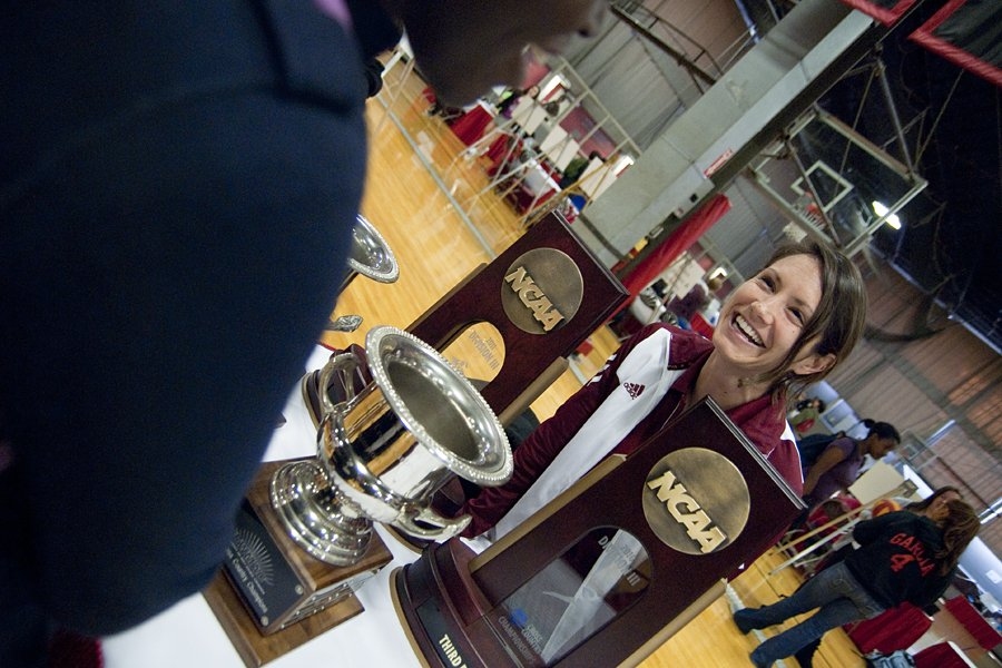 Summer Hutcheson, assistant coach for track & field, talks about MIT athletics with a prefrosh in the Athletics, Physical Education, and Recreation Fair in the Rockwell Cage on Friday.