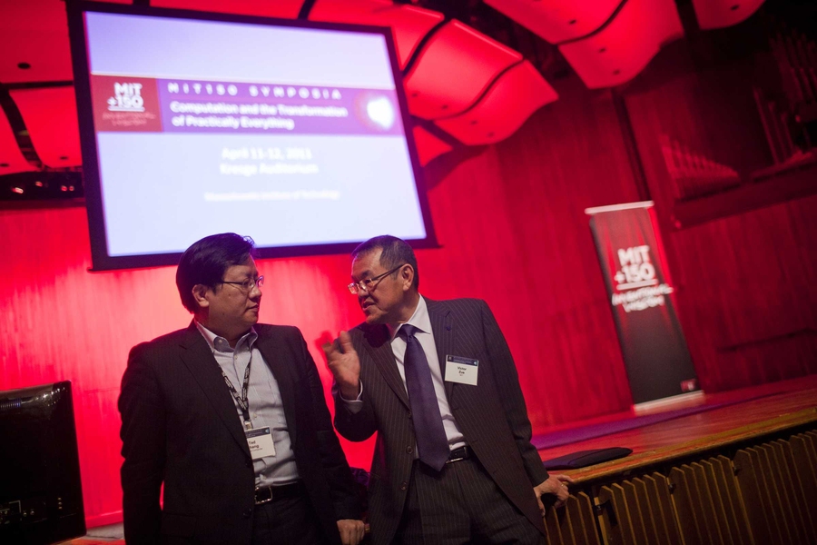 Computer Science and Artificial Intelligence Laboratory director Victor Zue chats with a symposium attendee between sessions.
