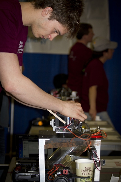 Sophomore Wyatt Ubellacker, who went on to win this year's 2.007 competition, works with one of his three robots.
