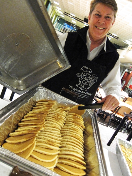Students take a break during finals week for free breakfast at night during Flapjacks for Finals at the Stratton Student Center on May 15. MIT Police Sergeant Cheryl Vossmer, who founded the event 12 years ago, shows the flapjacks that will power MIT undergraduates through their finals.