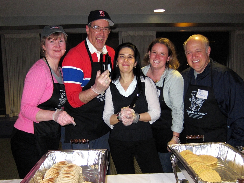 Professor Paul Lagace and his wife, Robin (far left), have been serving pancakes since the first Flapjacks event 12 years ago. Another server, Dean for Student Life Chris Colombo (far right), serves alongside Keri Mills, assistant director in Student Activities, and a catering manager for Sodexho (center).