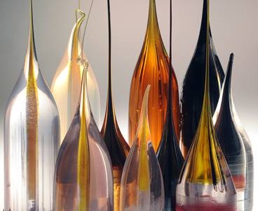Samples of materials that have been made into fibers in the lab of MIT’s Yoel Fink. The initial material is made into a 'preform,' in the lower portion, which is then heated and drawn out like taffy into a fiber from the top, preserving the arrangement of materials within the structure.