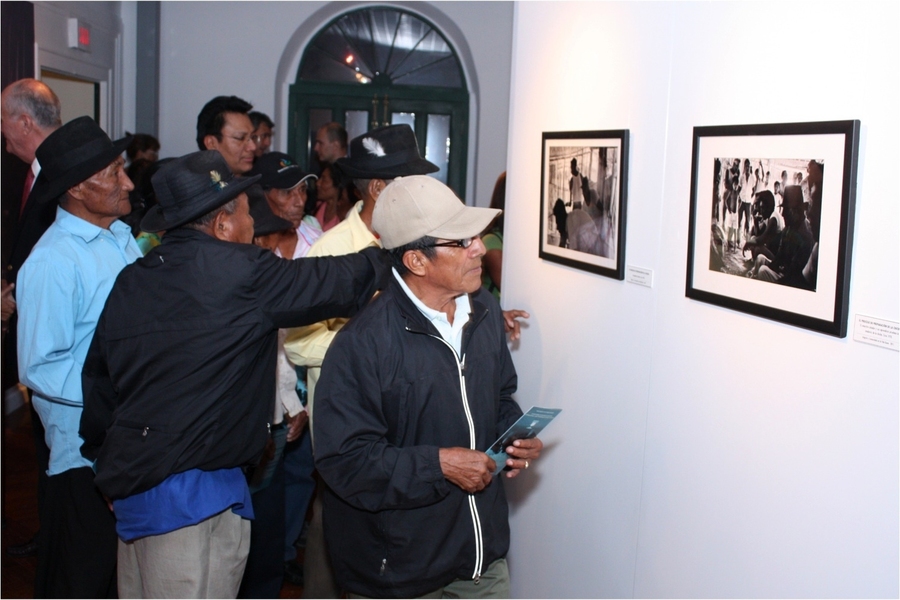 Kuna chiefs compare notes on photos of brewing and tasting cane beer.
