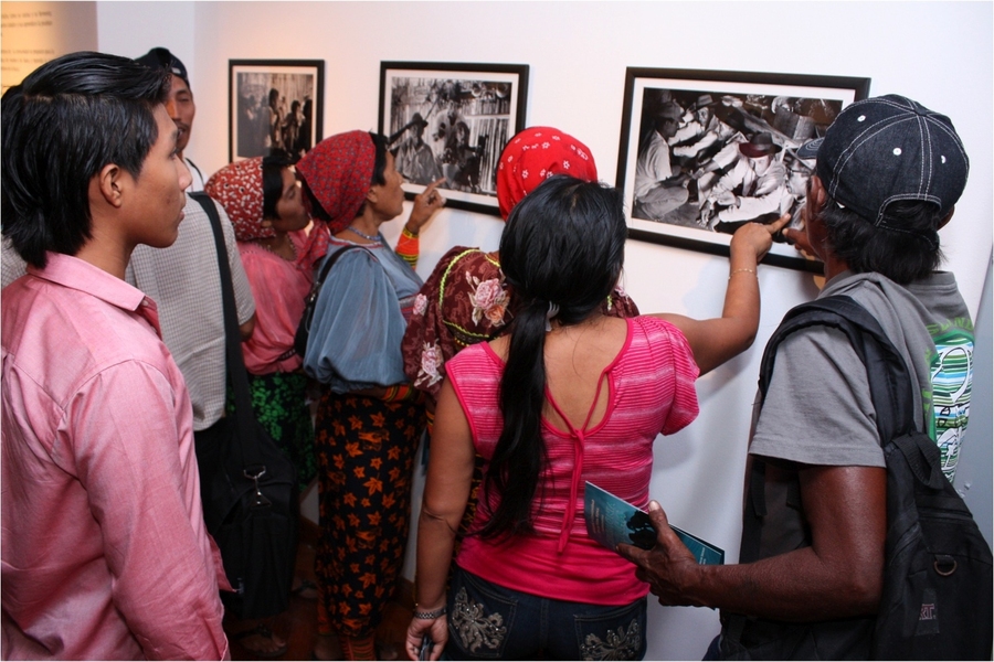 Kuna women examine images of communal celebrations.