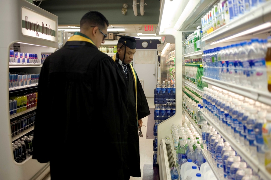 Two graduates grab some drinks before the ceremony.